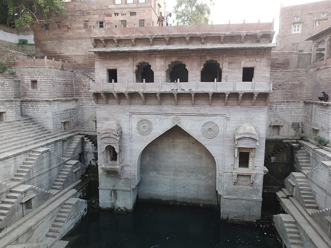 Carved arches above the water at Toorji ka Jhalra