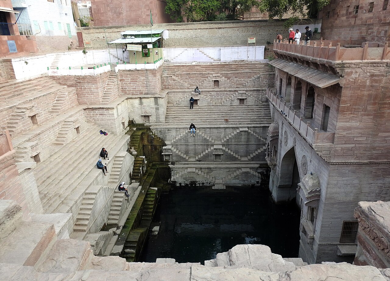 Sandstone stairways descending into Toorji ka Jhalra