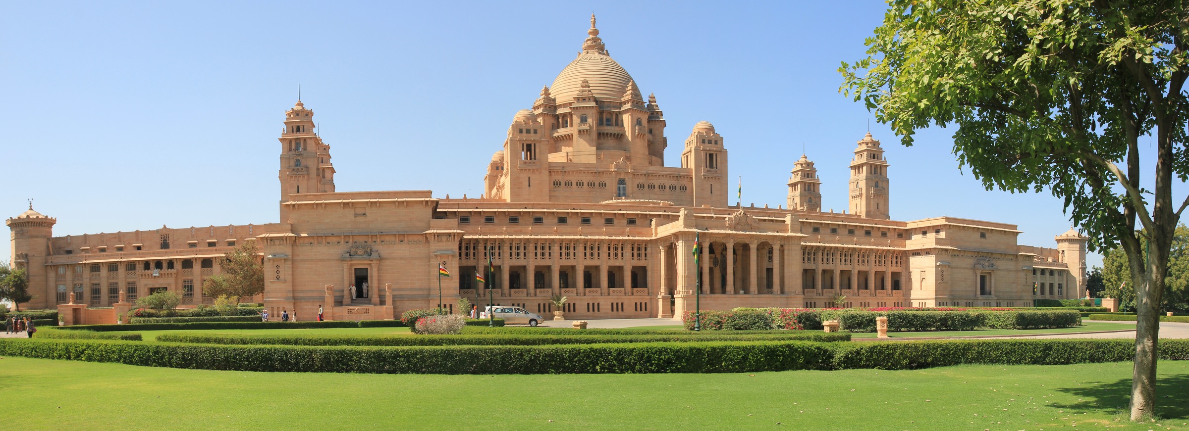 Umaid Bhawan Palace’s sandstone dome and towers above formal gardens in Jodhpur.